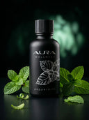 Black bottle of Aura Wellness Peppermint product with mint leaves on a dark background